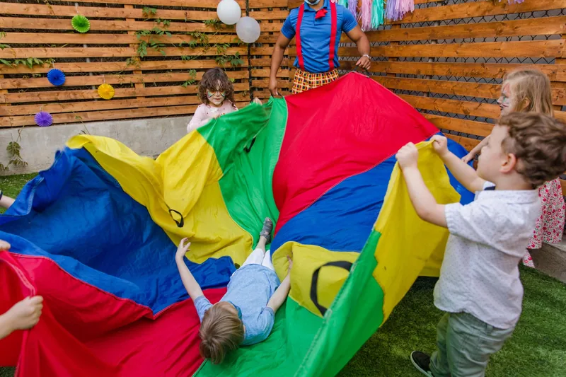 Children playing a group parachute game at summer camp