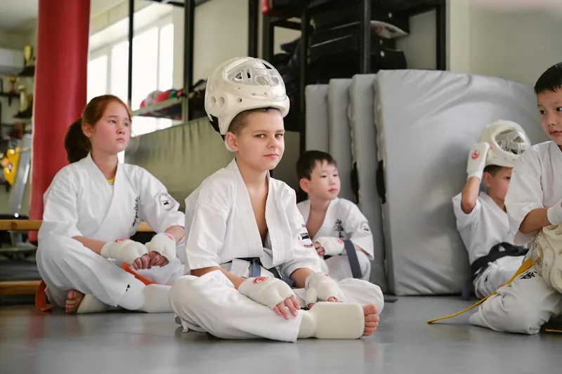 Children practicing focus and discipline during martial arts class